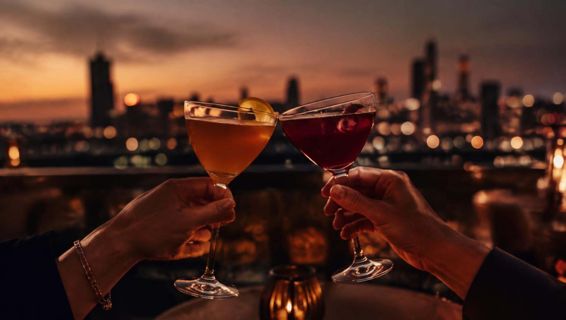 Two cocktails clinking over a city skyline at dusk